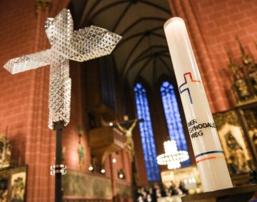 Ein Kreuz und eine Kerze mit dem Logo des Synodalen Wegs beim Gottesdienst zur Eröffnung der Synodalversammlung am 30. Januar 2020 im Frankfurter Dom Sankt Bartholomäus.