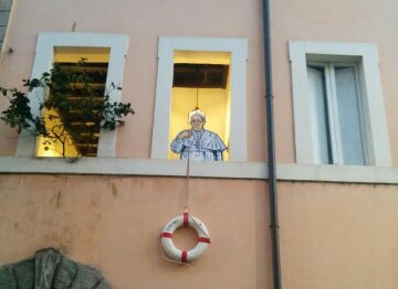 Kunstinstallation des Graffitikünstlers Maupal in Rom am 22. Februar 2019. Sie zeigt eine Figur von Papst Franziskus, der einen Rettungsring an einer Leine aus einem Fenster hält.