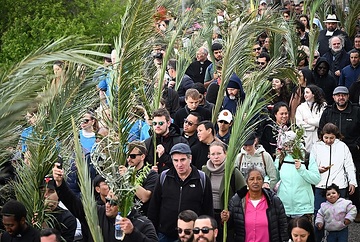 Christen mit Palmenblättern und Olivenzweigen, während der Palmsonntagsprozession auf dem Ölberg in Jerusalem (Israel) am 24. März 2024.